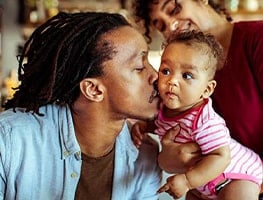 Dad kissing his 5 week old baby