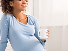 Week 16 pregnant woman enjoying a beverage