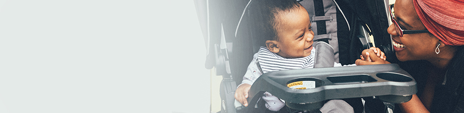 Mom chatting to her baby in a stroller