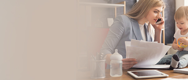 Mom working with baby on her desk