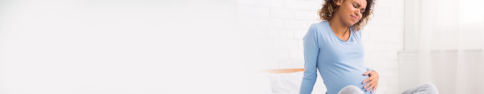Pregnant woman in pain holding her stomach