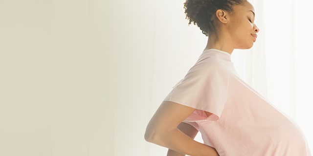 Week 38 pregnant woman experiencing back discomfort